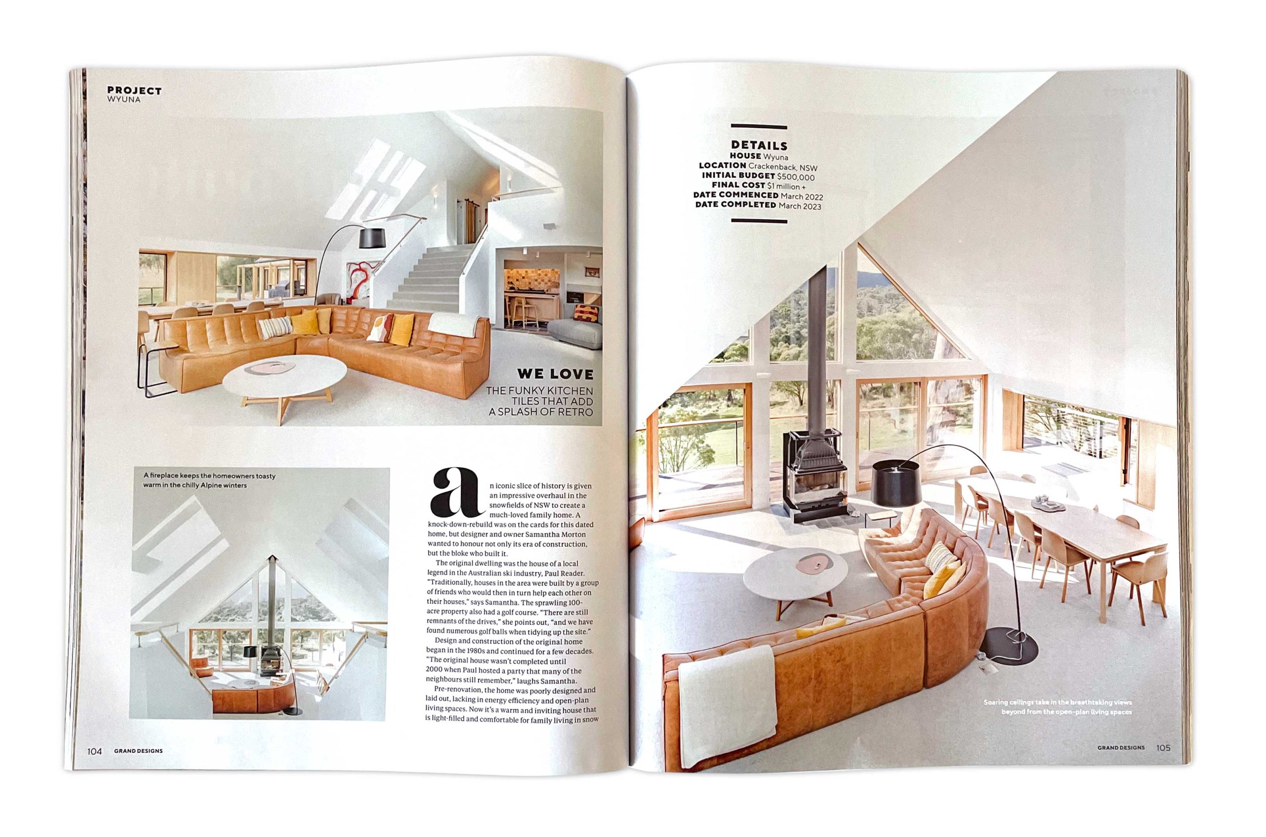 Grand Designs Australia magazine feature spread showing the open-plan interior of House Wyuna in Crackenback, NSW, with a curved tan leather lounge, timber windows, high vaulted ceilings and alpine views.